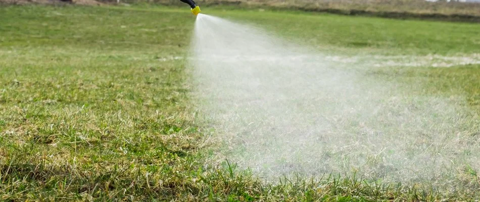 Liquid fertilizer being sprayed on green grass in Mansfield, OH.