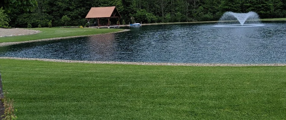 Lush, green lawn in Mansfield, OH, beside a lake.