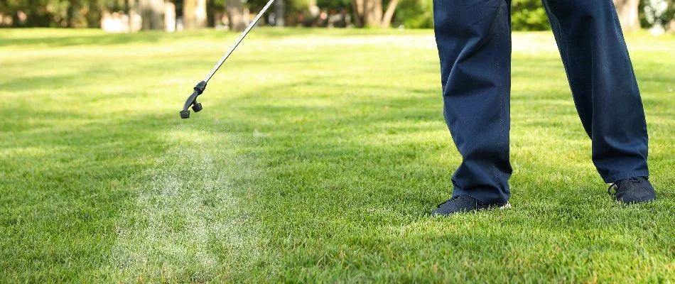 Professional spraying liquid fertilizer on grass in Mansfield, OH.