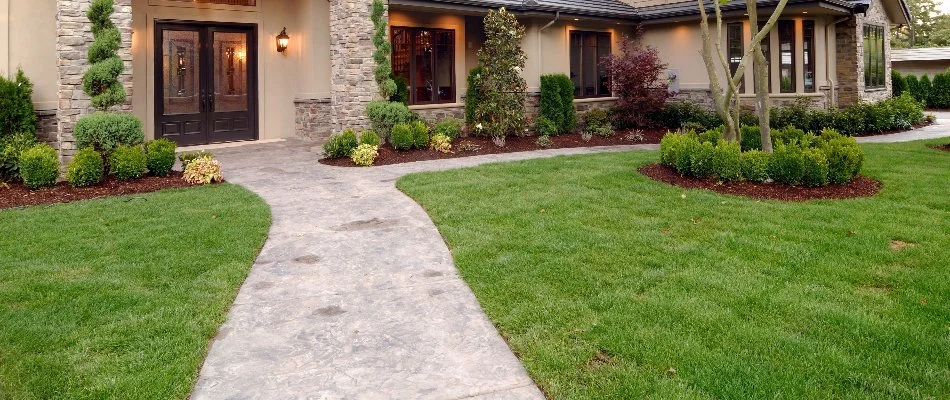 Healthy lawn in Munroe Falls, OH, with landscape beds.