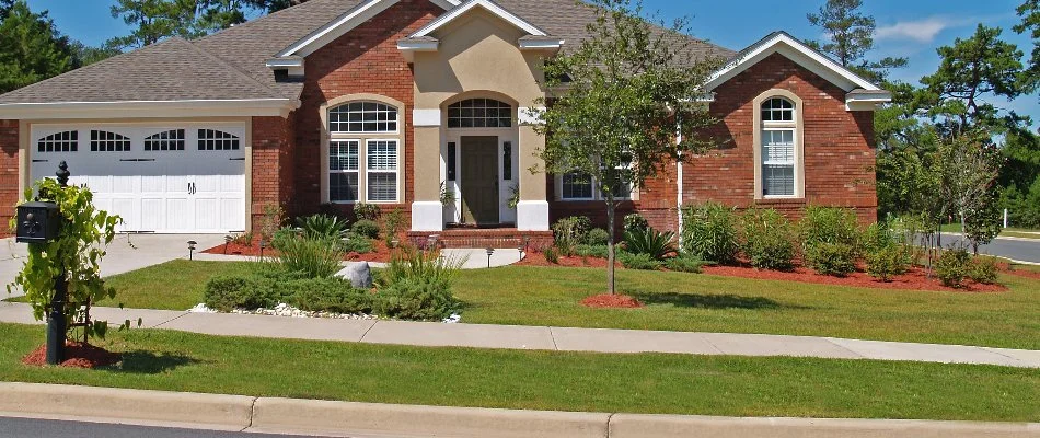 House in Orrville, OH, with healthy grass and plants.