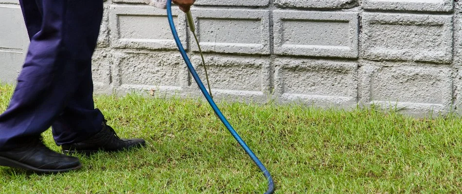 Perimeter pest control being applied to the side of a home in Mansfield, OH.